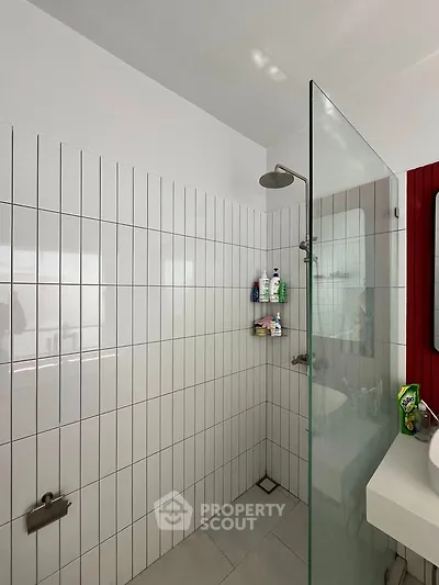 Modern bathroom with glass shower and tiled walls