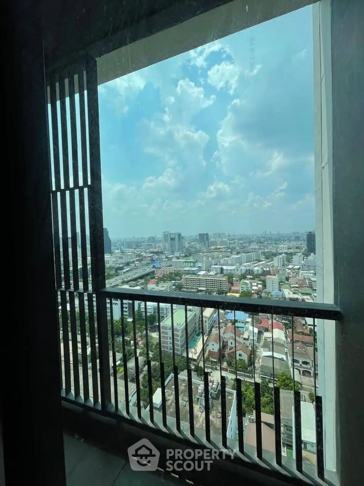 Stunning cityscape view from high-rise balcony with expansive skyline.