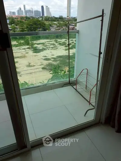 Spacious balcony with city view, perfect for relaxation and enjoying the skyline.