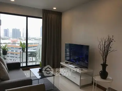 Modern living room with city view, featuring sleek furniture and large windows for natural light.