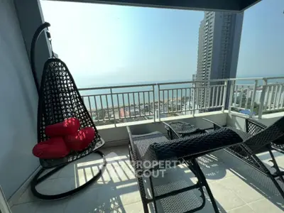 Stunning balcony with ocean view and modern outdoor furniture in high-rise apartment