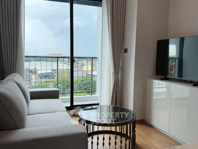Modern living room with a stunning view, featuring a sleek sofa, stylish coffee table, and large TV.