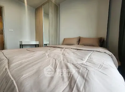 Cozy bedroom with modern decor and soft bedding in a stylish apartment.