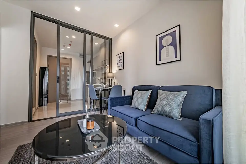 Modern living room with blue sofa and stylish decor in a contemporary apartment.