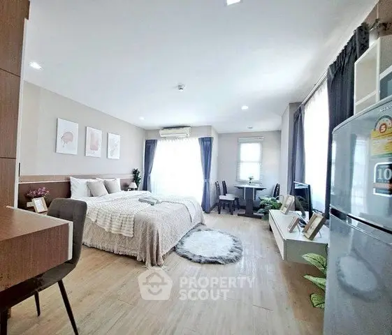 Spacious modern studio apartment with cozy decor and natural light