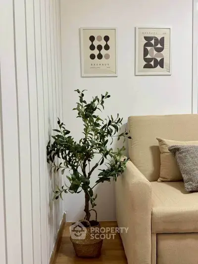 Stylish living room corner with modern decor and cozy beige sofa.