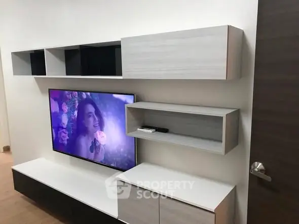 Modern living room with sleek TV unit and storage shelves