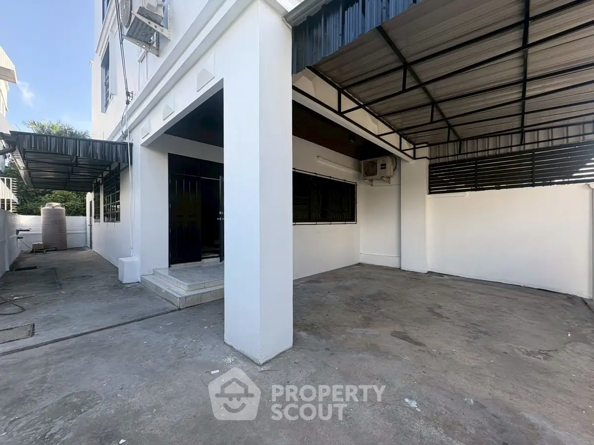 Spacious covered parking area in modern residential building with sleek design.