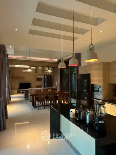 Luxurious modern kitchen with sleek appliances and open layout in a spacious home.