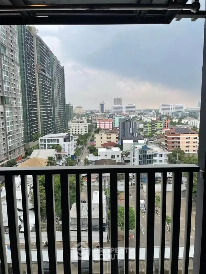 Stunning cityscape view from a high-rise balcony overlooking urban skyline.