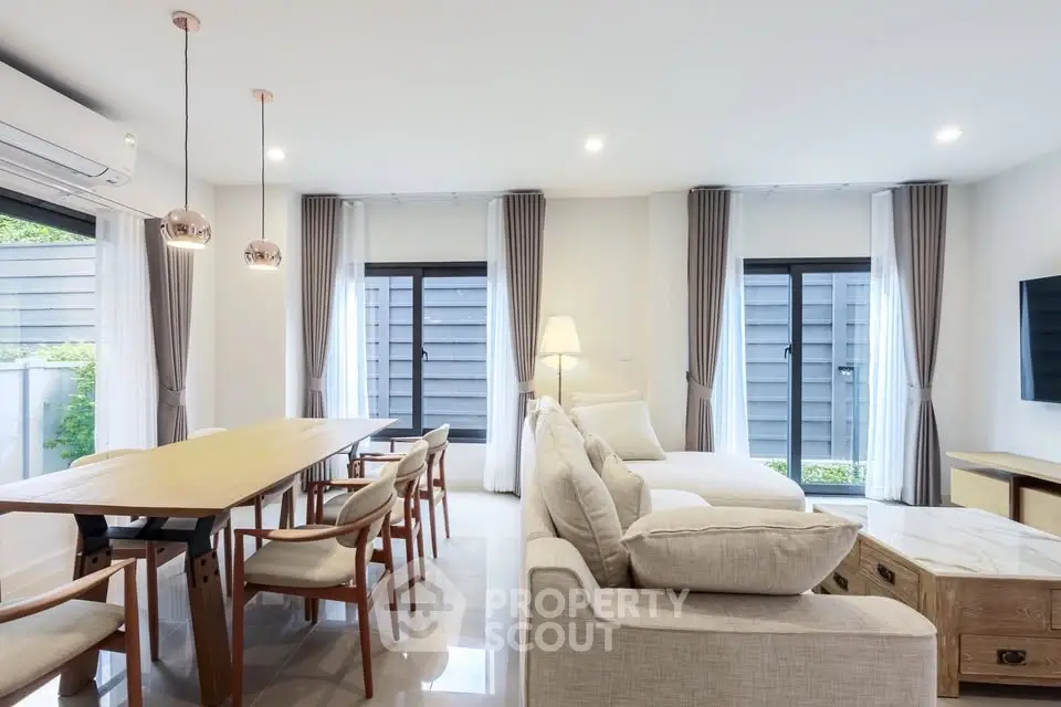 Spacious modern living room with elegant dining area and natural light