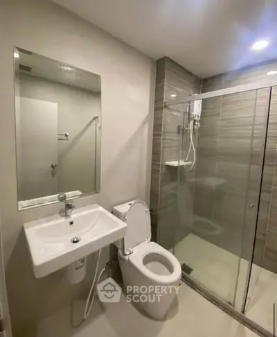 Modern bathroom with sleek design, glass shower, and contemporary fixtures.