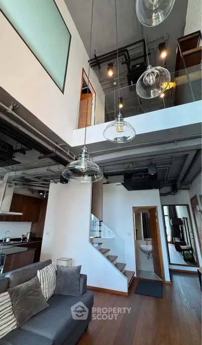 Modern loft apartment with open layout, stylish lighting, and mezzanine level.
