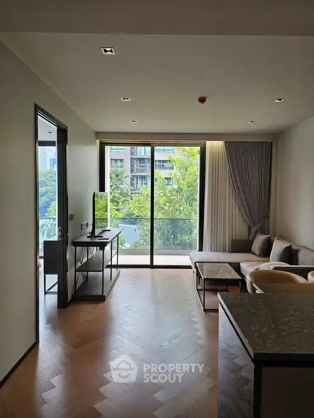 Modern living room with large windows and balcony view in luxury apartment.