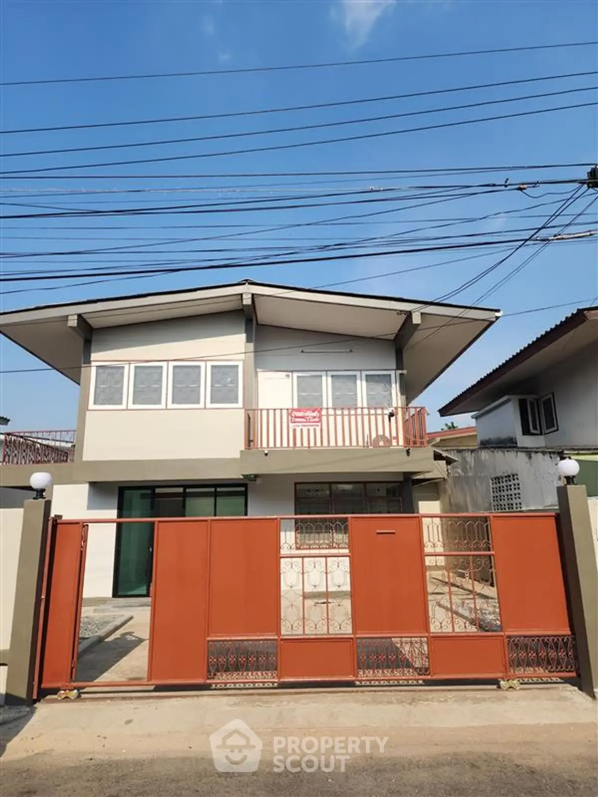 Charming two-story house with modern design and gated entrance in a serene neighborhood.