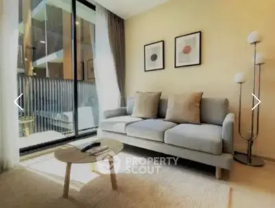 Modern living room with cozy sofa and natural light, perfect for relaxation.