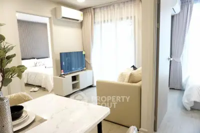 Modern apartment interior with open layout, featuring a cozy living area and stylish bedroom.