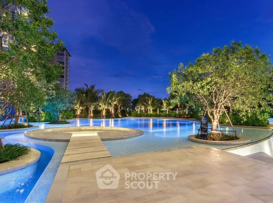 Luxurious resort-style swimming pool with lush landscaping and serene ambiance at twilight.