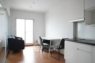 Modern minimalist apartment interior with open kitchen and cozy living area.