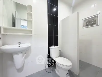 Modern bathroom with sleek white tiles and minimalist fixtures