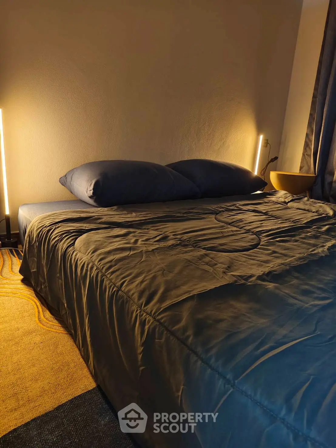 Cozy bedroom with modern lighting and stylish bedding
