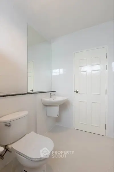 Modern minimalist bathroom with white tiles and sleek fixtures