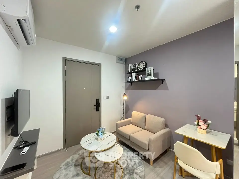 Modern living room with cozy sofa, stylish decor, and wall-mounted TV in a chic apartment.