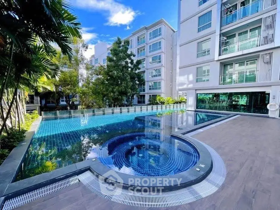 Luxurious apartment complex with stunning pool and modern architecture.