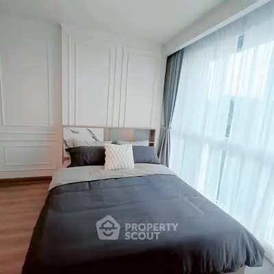 Modern bedroom with large window and stylish decor