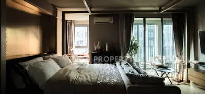 Luxurious bedroom with large windows and balcony in modern apartment