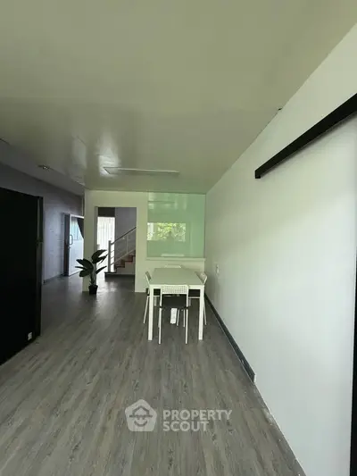 Spacious modern living area with sleek flooring and minimalist decor, perfect for contemporary living.