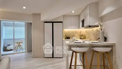Modern kitchen with open layout and stylish breakfast bar in contemporary apartment.