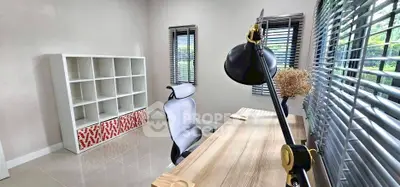 Modern study room with sleek desk, ergonomic chair, and large windows for natural light.