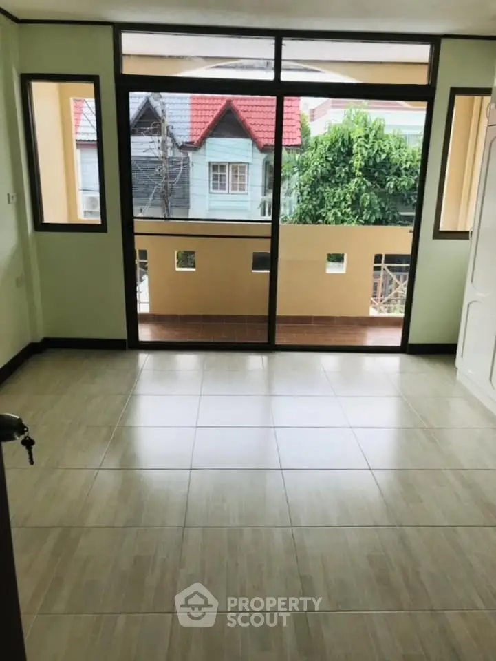 Spacious room with large windows and balcony access in a modern home.