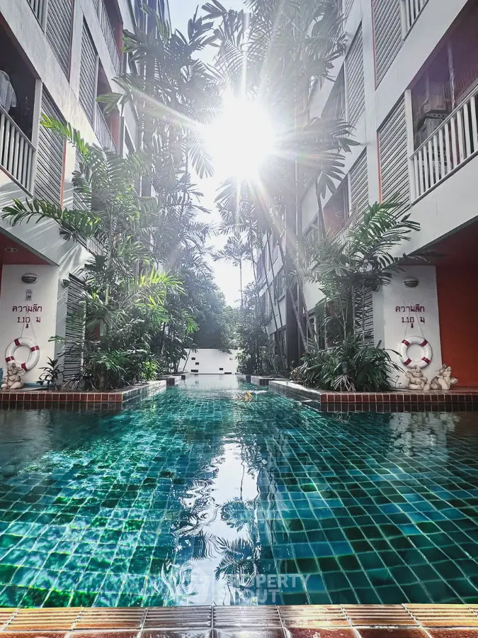 Stunning pool area with lush greenery and modern architecture, perfect for relaxation and leisure.