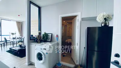 Modern apartment interior with washing machine and dining area