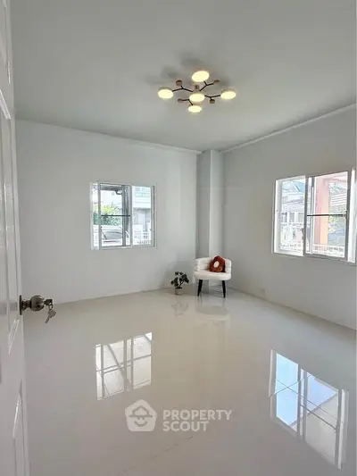 Bright minimalist room with modern lighting and large windows