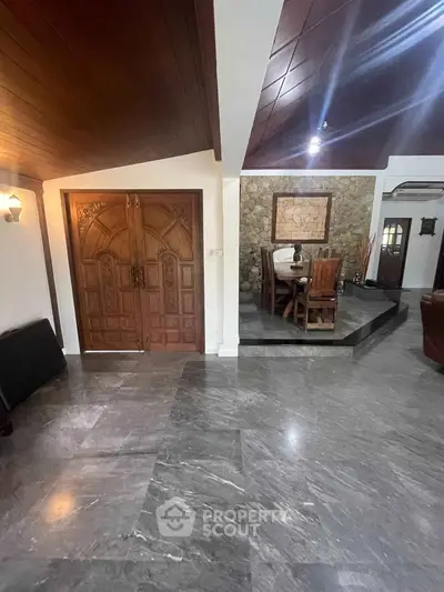 Elegant interior with marble flooring and wooden accents in a spacious living area.