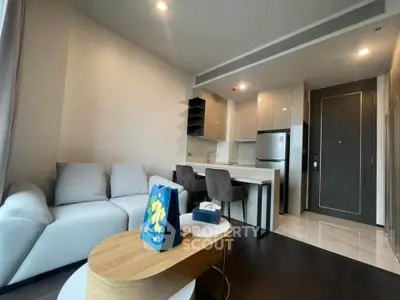 Modern living room with sleek kitchen and cozy seating area