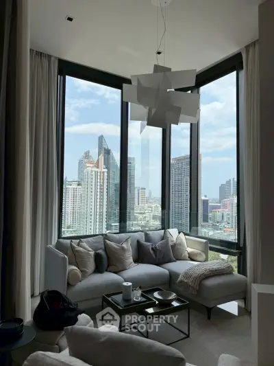 Luxurious corner living room with panoramic city views and modern decor.