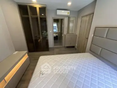 Modern bedroom with stylish furniture and ample storage space in a contemporary apartment.