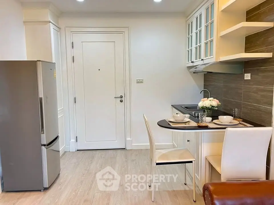 Charming kitchen with dining area, modern appliances, and elegant decor.