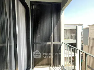 Modern balcony with sleek railing and urban view, perfect for relaxation and enjoying city life.