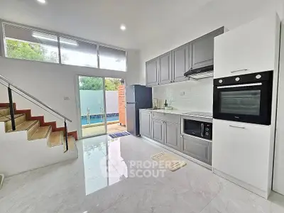 Modern kitchen with sleek appliances and pool view, perfect for culinary enthusiasts.