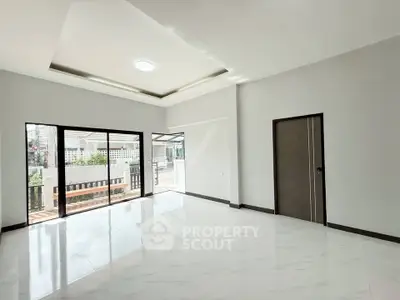 Spacious modern living room with large windows and elegant ceiling design