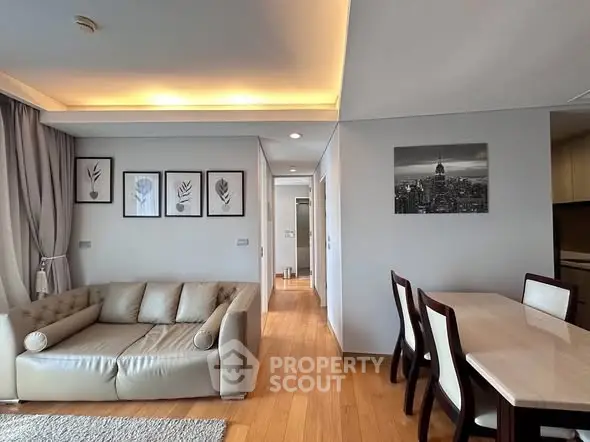 Modern living room with elegant decor and dining area in a stylish apartment.