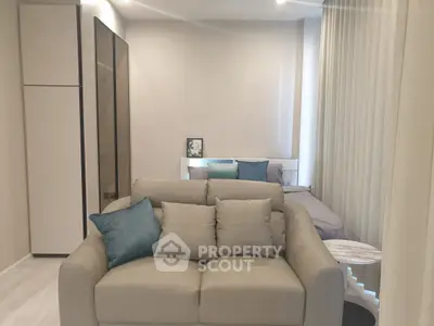 Modern studio apartment with cozy living area and stylish decor