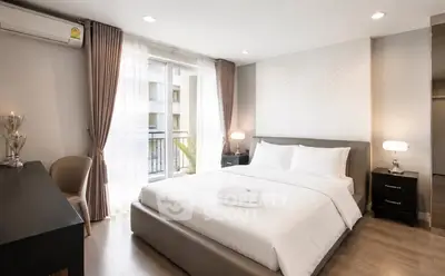 Luxurious bedroom with elegant decor and natural light in modern apartment