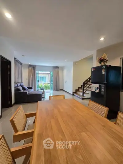 Spacious open-plan living and dining area with modern furnishings and natural light.