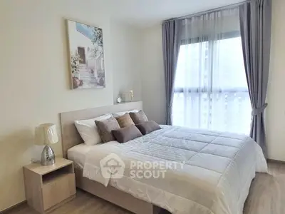 Elegant bedroom with modern decor and large window for natural light